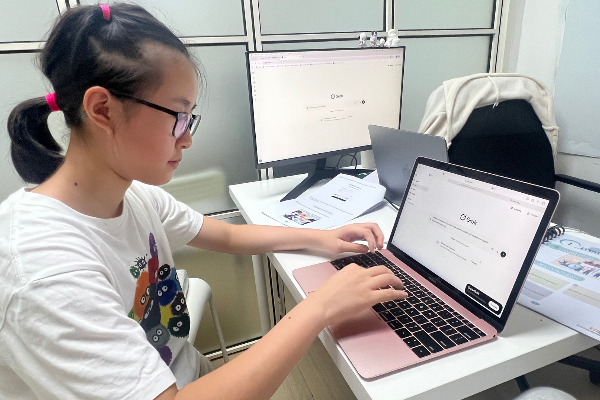 Children collaborating happily at Encode Education's AI Summer Camp in Hong Kong.