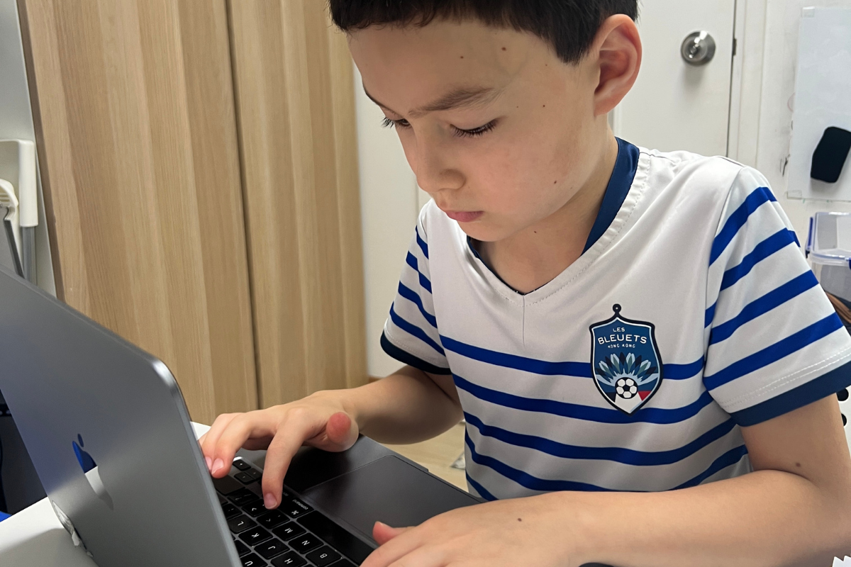 An Encode Education student using computational logic alongside AI tools in a Hong Kong classroom.