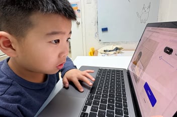 An Encode Education student using computational logic alongside AI tools in a Hong Kong classroom.