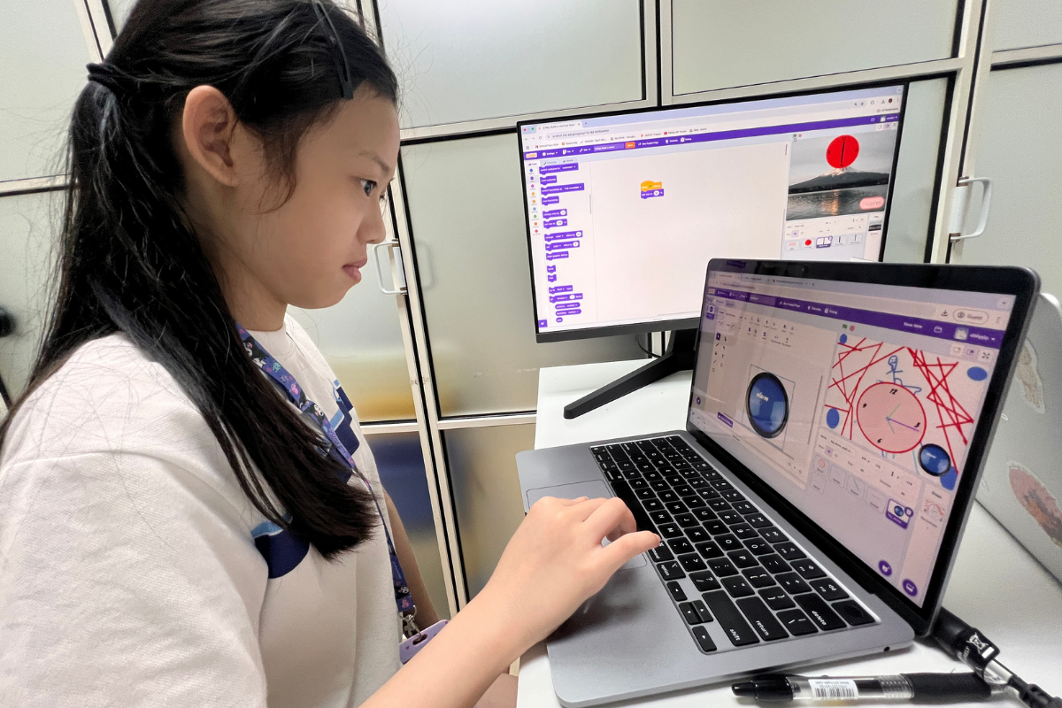 Students and an instructor at Encode Education working together in a welcoming Hong Kong classroom.
