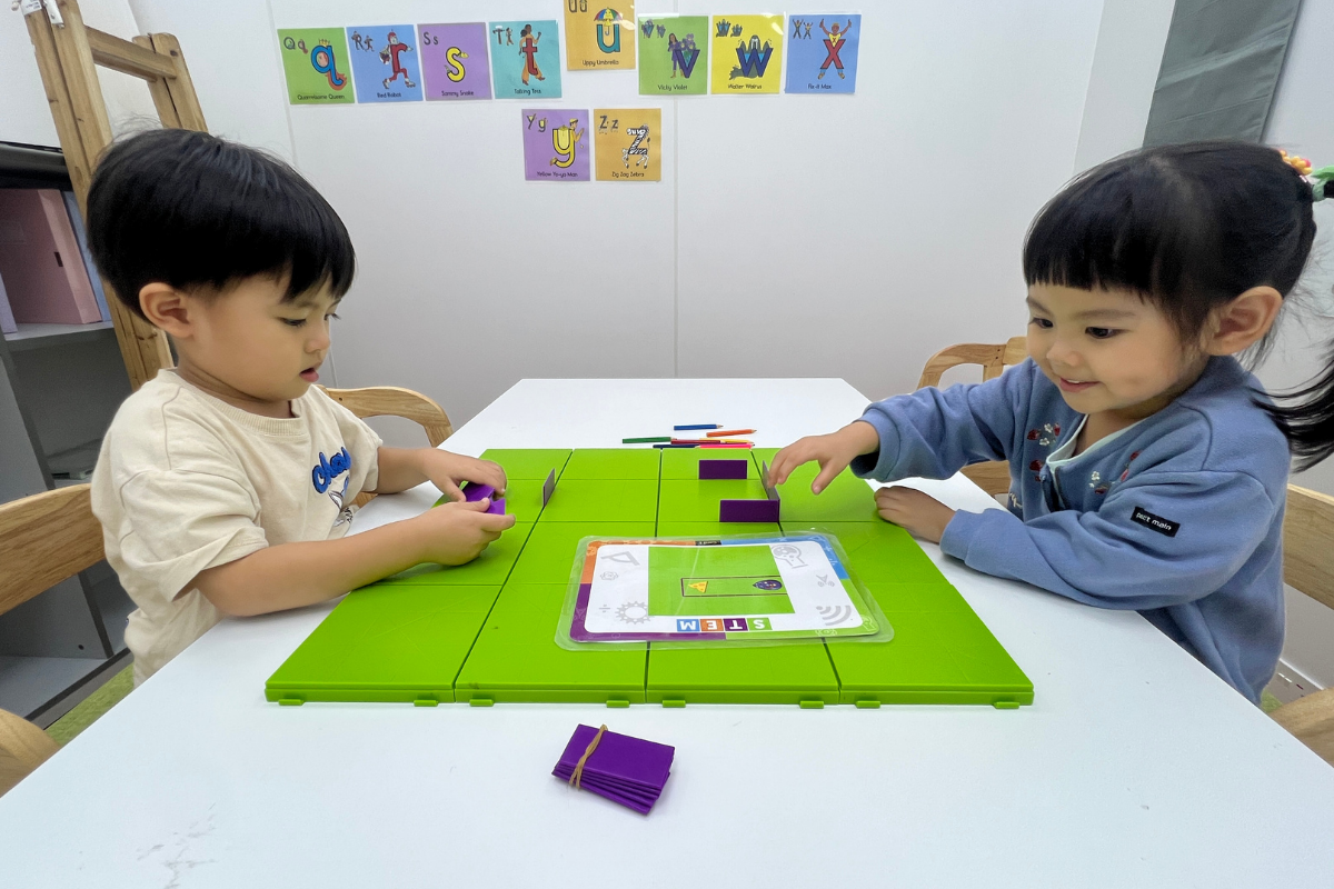 Young children in Hong Kong learning screen-free coding logic using tactile toy blocks at Encode Education.