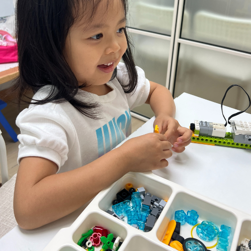 girl playing lego